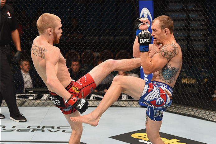 LAS VEGAS, NV - MAY 23: (L-R) Justin Scoggins kicks Joshua Sampo in their flyweight bout during the UFC 187 event at the MGM Grand Garden Arena on May 23, 2015 in Las Vegas, Nevada. (Photo by Josh Hedges/Zuffa LLC/Zuffa LLC via Getty Images)