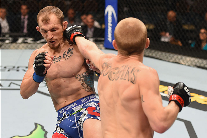LAS VEGAS, NV - MAY 23: (R-L) Justin Scoggins punches Joshua Sampo in their flyweight bout during the UFC 187 event at the MGM Grand Garden Arena on May 23, 2015 in Las Vegas, Nevada. (Photo by Josh Hedges/Zuffa LLC/Zuffa LLC via Getty Images)