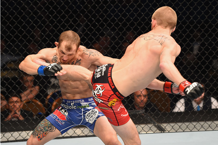 LAS VEGAS, NV - MAY 23: (R-L) Justin Scoggins kicks Joshua Sampo in their flyweight bout during the UFC 187 event at the MGM Grand Garden Arena on May 23, 2015 in Las Vegas, Nevada. (Photo by Josh Hedges/Zuffa LLC/Zuffa LLC via Getty Images)