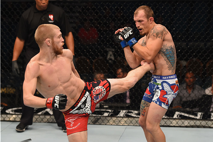 LAS VEGAS, NV - MAY 23: (L-R) Justin Scoggins kicks Joshua Sampo in their flyweight bout during the UFC 187 event at the MGM Grand Garden Arena on May 23, 2015 in Las Vegas, Nevada. (Photo by Josh Hedges/Zuffa LLC/Zuffa LLC via Getty Images)
