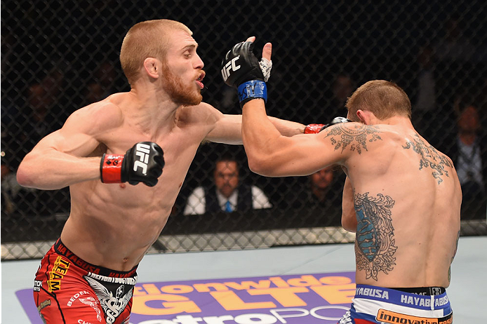 LAS VEGAS, NV - MAY 23: (L-R) Justin Scoggins punches Joshua Sampo in their flyweight bout during the UFC 187 event at the MGM Grand Garden Arena on May 23, 2015 in Las Vegas, Nevada. (Photo by Josh Hedges/Zuffa LLC/Zuffa LLC via Getty Images)