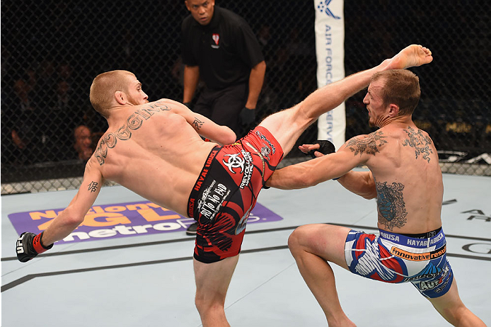 LAS VEGAS, NV - MAY 23:  (L-R) Justin Scoggins kicks Joshua Sampo in their flyweight bout during the UFC 187 event at the MGM Grand Garden Arena on May 23, 2015 in Las Vegas, Nevada.  (Photo by Josh Hedges/Zuffa LLC/Zuffa LLC via Getty Images)