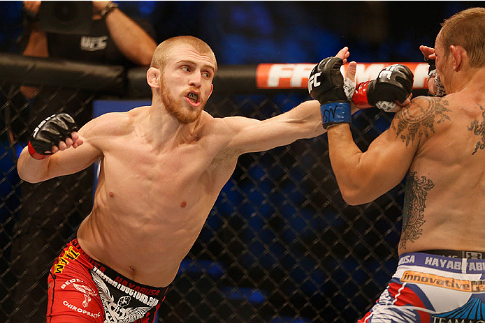 LAS VEGAS, NV - MAY 23: (L-R) Justin Scoggins punches Joshua Sampo in their flyweight bout during the UFC 187 event at the MGM Grand Garden Arena on May 23, 2015 in Las Vegas, Nevada. (Photo by Christian Petersen/Zuffa LLC/Zuffa LLC via Getty Images)