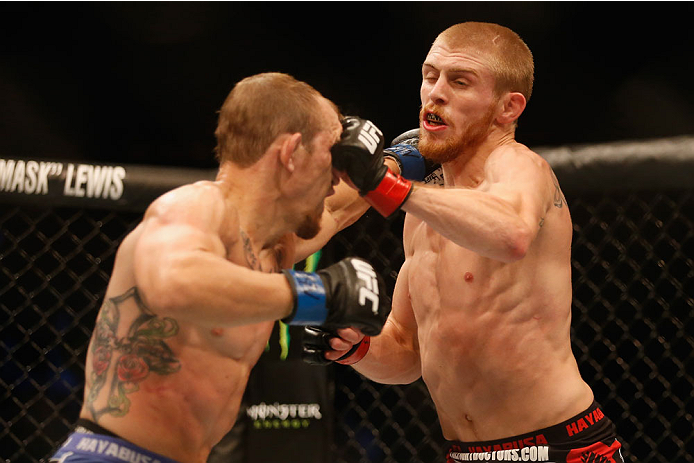 LAS VEGAS, NV - MAY 23:  (R-L) Justin Scoggins punches Joshua Sampo in their flyweight bout during the UFC 187 event at the MGM Grand Garden Arena on May 23, 2015 in Las Vegas, Nevada.  (Photo by Christian Petersen/Zuffa LLC/Zuffa LLC via Getty Images)