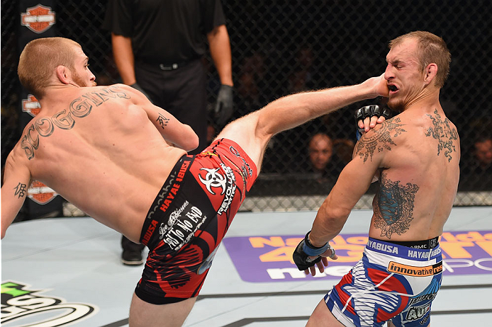 LAS VEGAS, NV - MAY 23:  (L-R) Justin Scoggins kicks Joshua Sampo in their flyweight bout during the UFC 187 event at the MGM Grand Garden Arena on May 23, 2015 in Las Vegas, Nevada.  (Photo by Josh Hedges/Zuffa LLC/Zuffa LLC via Getty Images)