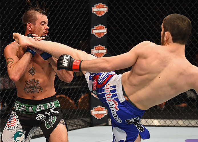 LAS VEGAS, NV - MAY 23: (R-L) Islam Makhachev of Russia kicks Leo Kuntz in their lightweight bout during the UFC 187 event at the MGM Grand Garden Arena on May 23, 2015 in Las Vegas, Nevada. (Photo by Josh Hedges/Zuffa LLC/Zuffa LLC via Getty Images)
