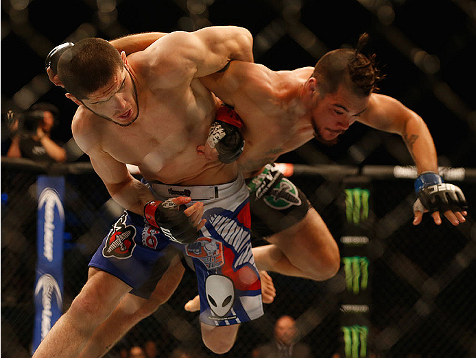 LAS VEGAS, NV - MAY 23:  (L-R) Islam Makhachev of Russia throws Leo Kuntz in their lightweight bout during the UFC 187 event at the MGM Grand Garden Arena on May 23, 2015 in Las Vegas, Nevada.  (Photo by Christian Petersen/Zuffa LLC/Zuffa LLC via Getty Im