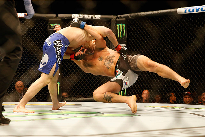 LAS VEGAS, NV - MAY 23:  Islam Makhachev of Russia (blue shorts) slams Leo Kuntz to the mat in their lightweight bout during the UFC 187 event at the MGM Grand Garden Arena on May 23, 2015 in Las Vegas, Nevada.  (Photo by Christian Petersen/Zuffa LLC/Zuff