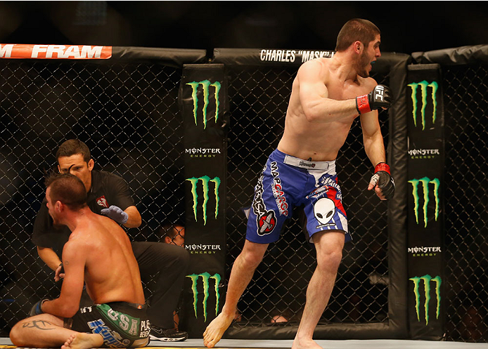 LAS VEGAS, NV - MAY 23: Islam Makhachev of Russia (blue shorts) reacts to his victory over Leo Kuntz (left) in their lightweight bout during the UFC 187 event at the MGM Grand Garden Arena on May 23, 2015 in Las Vegas, Nevada. (Photo by Christian Peters