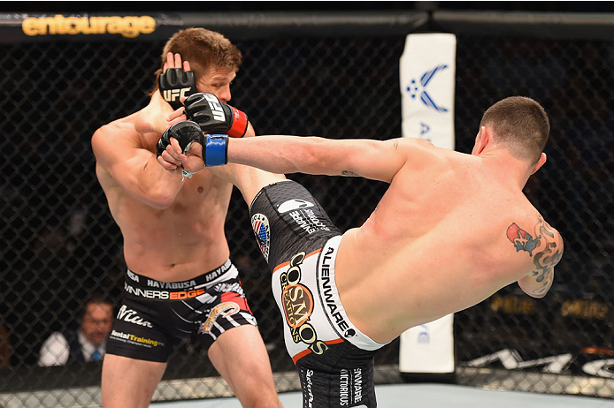 LAS VEGAS, NV - MAY 23: (R-L) Colby Covington kicks Mike Pyle in their welterweight bout during the UFC 187 event at the MGM Grand Garden Arena on May 23, 2015 in Las Vegas, Nevada. (Photo by Josh Hedges/Zuffa LLC/Zuffa LLC via Getty Images)
