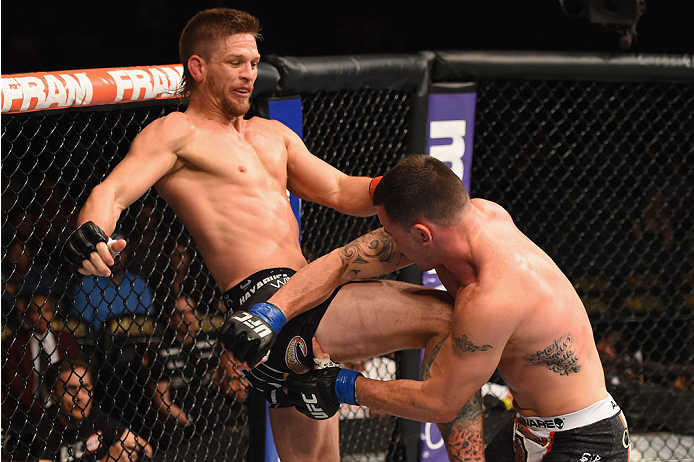 LAS VEGAS, NV - MAY 23: (L-R) Mike Pyle kicks Colby Covington in their welterweight bout during the UFC 187 event at the MGM Grand Garden Arena on May 23, 2015 in Las Vegas, Nevada. (Photo by Josh Hedges/Zuffa LLC/Zuffa LLC via Getty Images)