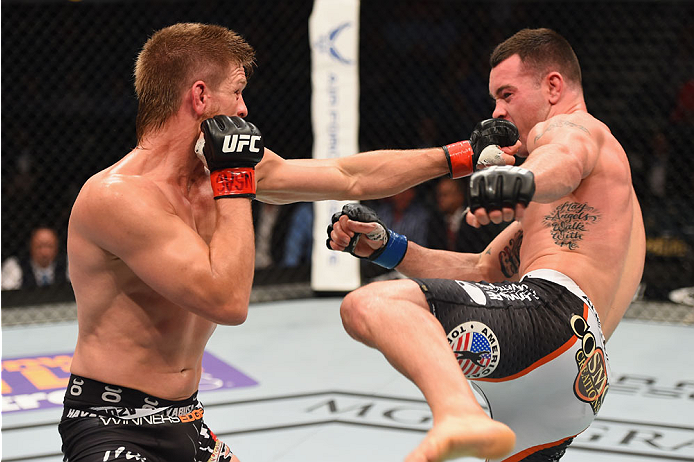 LAS VEGAS, NV - MAY 23: (L-R) Mike Pyle punches Colby Covington in their welterweight bout during the UFC 187 event at the MGM Grand Garden Arena on May 23, 2015 in Las Vegas, Nevada. (Photo by Josh Hedges/Zuffa LLC/Zuffa LLC via Getty Images)