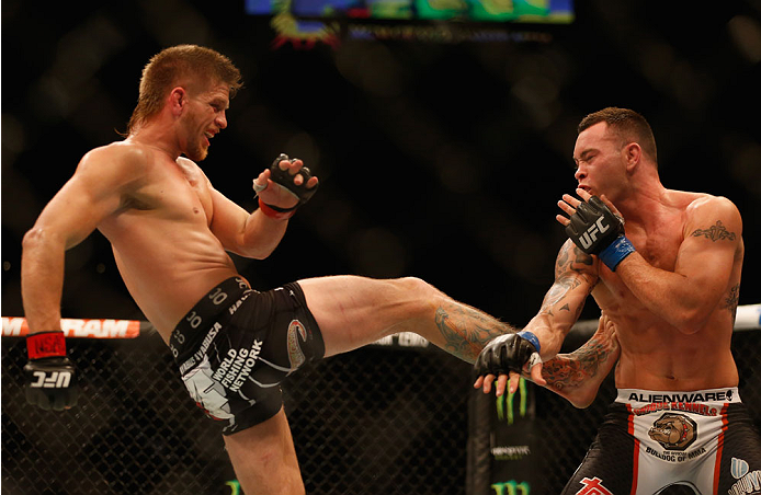 LAS VEGAS, NV - MAY 23:  (L-R) Mike Pyle kicks Colby Covington in their welterweight bout during the UFC 187 event at the MGM Grand Garden Arena on May 23, 2015 in Las Vegas, Nevada.  (Photo by Christian Petersen/Zuffa LLC/Zuffa LLC via Getty Images)