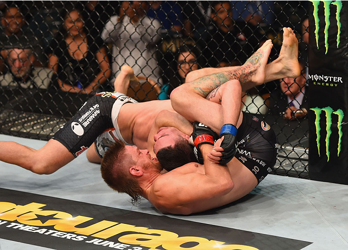 LAS VEGAS, NV - MAY 23: Mike Pyle (bottom) attempts to submit Colby Covington in their welterweight bout during the UFC 187 event at the MGM Grand Garden Arena on May 23, 2015 in Las Vegas, Nevada. (Photo by Josh Hedges/Zuffa LLC/Zuffa LLC via Getty Ima