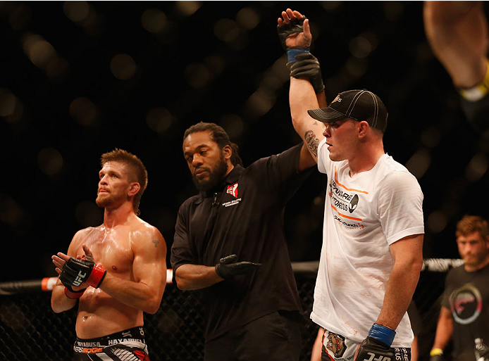 LAS VEGAS, NV - MAY 23:  Colby Covington (right) is declared the winner over Mike Pyle (left) in their welterweight bout during the UFC 187 event at the MGM Grand Garden Arena on May 23, 2015 in Las Vegas, Nevada.  (Photo by Christian Petersen/Zuffa LLC/Z