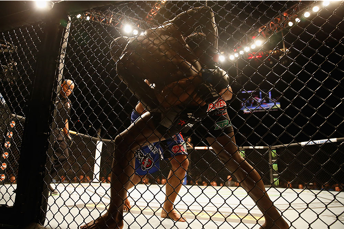 LAS VEGAS, NV - MAY 23:  Rafael Natal of Brazil and Uriah Hall (front) grapple against the Octagon fence in their middleweight bout during the UFC 187 event at the MGM Grand Garden Arena on May 23, 2015 in Las Vegas, Nevada.  (Photo by Christian Petersen/