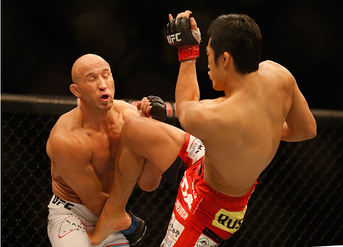 LAS VEGAS, NV - MAY 23:  (R-L) Dong Hyun Kim kicks Josh Burkman in their welterweight bout during the UFC 187 event at the MGM Grand Garden Arena on May 23, 2015 in Las Vegas, Nevada.  (Photo by Christian Petersen/Zuffa LLC/Zuffa LLC via Getty Images)