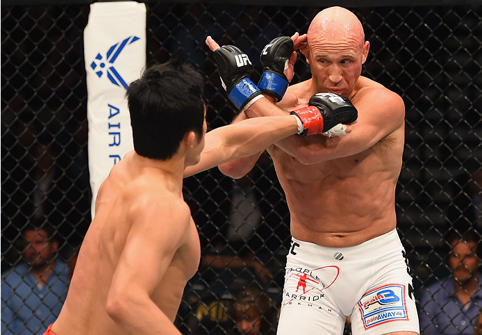 LAS VEGAS, NV - MAY 23:  (L-R) Dong Hyun Kim punches Josh Burkman in their welterweight bout during the UFC 187 event at the MGM Grand Garden Arena on May 23, 2015 in Las Vegas, Nevada.  (Photo by Josh Hedges/Zuffa LLC/Zuffa LLC via Getty Images)