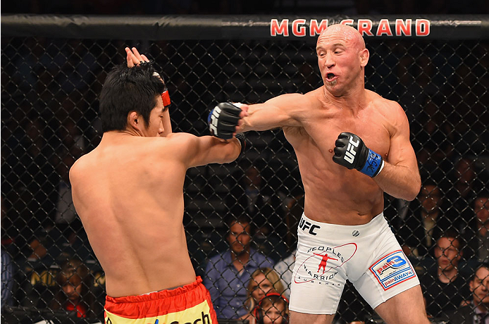 LAS VEGAS, NV - MAY 23: (R-L) Josh Burkman punches Dong Hyun Kim in their welterweight bout during the UFC 187 event at the MGM Grand Garden Arena on May 23, 2015 in Las Vegas, Nevada. (Photo by Josh Hedges/Zuffa LLC/Zuffa LLC via Getty Images)
