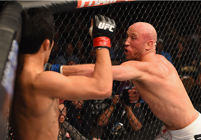 LAS VEGAS, NV - MAY 23: (R-L) Josh Burkman punches Dong Hyun Kim in their welterweight bout during the UFC 187 event at the MGM Grand Garden Arena on May 23, 2015 in Las Vegas, Nevada. (Photo by Josh Hedges/Zuffa LLC/Zuffa LLC via Getty Images)