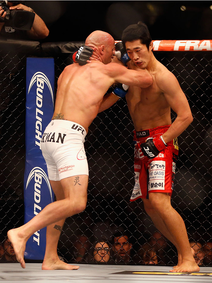 LAS VEGAS, NV - MAY 23: (L-R) Josh Burkman punches Dong Hyun Kim in their welterweight bout during the UFC 187 event at the MGM Grand Garden Arena on May 23, 2015 in Las Vegas, Nevada. (Photo by Christian Petersen/Zuffa LLC/Zuffa LLC via Getty Images)