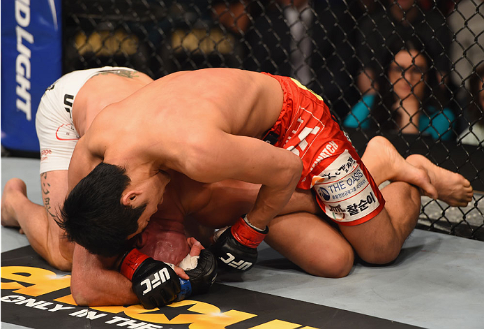 LAS VEGAS, NV - MAY 23: Dong Hyun Kim (top) punches Josh Burkman in their welterweight bout during the UFC 187 event at the MGM Grand Garden Arena on May 23, 2015 in Las Vegas, Nevada. (Photo by Josh Hedges/Zuffa LLC/Zuffa LLC via Getty Images)