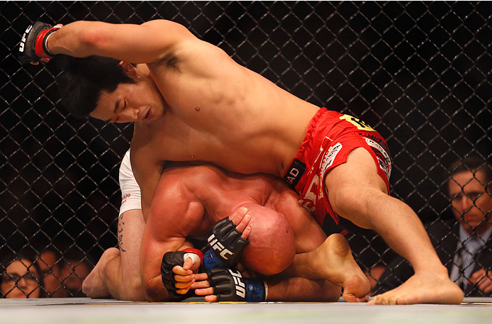 LAS VEGAS, NV - MAY 23:  Dong Hyun Kim  (top) punches Josh Burkman in their welterweight bout during the UFC 187 event at the MGM Grand Garden Arena on May 23, 2015 in Las Vegas, Nevada.  (Photo by Christian Petersen/Zuffa LLC/Zuffa LLC via Getty Images)