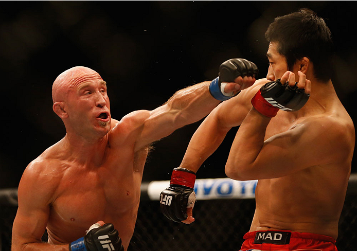 LAS VEGAS, NV - MAY 23: (L-R) Josh Burkman punches Dong Hyun Kim in their welterweight bout during the UFC 187 event at the MGM Grand Garden Arena on May 23, 2015 in Las Vegas, Nevada. (Photo by Christian Petersen/Zuffa LLC/Zuffa LLC via Getty Images)