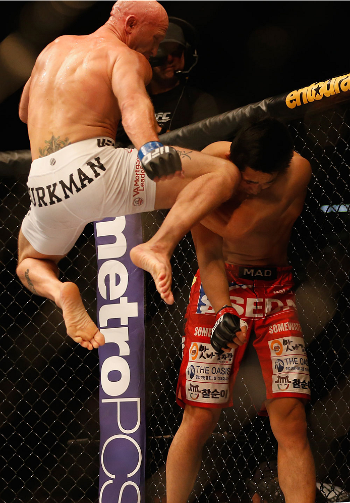 LAS VEGAS, NV - MAY 23: (L-R) Josh Burkman knees Dong Hyun Kim in their welterweight bout during the UFC 187 event at the MGM Grand Garden Arena on May 23, 2015 in Las Vegas, Nevada. (Photo by Christian Petersen/Zuffa LLC/Zuffa LLC via Getty Images)