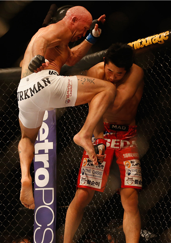 LAS VEGAS, NV - MAY 23: (L-R) Josh Burkman knees Dong Hyun Kim in their welterweight bout during the UFC 187 event at the MGM Grand Garden Arena on May 23, 2015 in Las Vegas, Nevada. (Photo by Christian Petersen/Zuffa LLC/Zuffa LLC via Getty Images)
