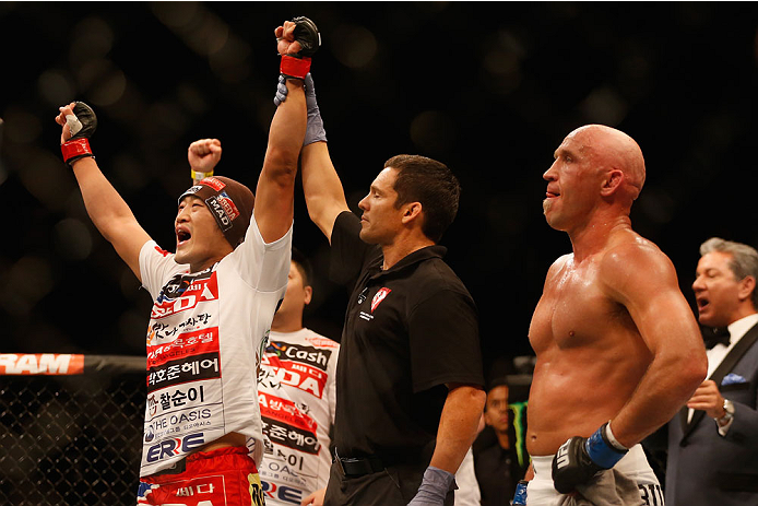 LAS VEGAS, NV - MAY 23:  Dong Hyun Kim  (left) reacts to his victory over Josh Burkman (right) in their welterweight bout during the UFC 187 event at the MGM Grand Garden Arena on May 23, 2015 in Las Vegas, Nevada.  (Photo by Christian Petersen/Zuffa LLC/