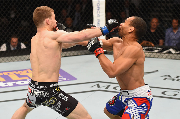 LAS VEGAS, NV - MAY 23:  (L-R) Zach Makovsky and John Dodson exchange punches in their flyweight bout during the UFC 187 event at the MGM Grand Garden Arena on May 23, 2015 in Las Vegas, Nevada.  (Photo by Josh Hedges/Zuffa LLC/Zuffa LLC via Getty Images)