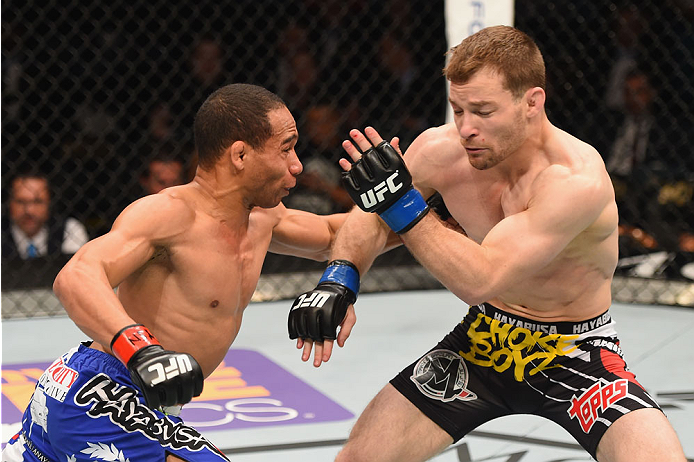 LAS VEGAS, NV - MAY 23: (L-R) John Dodson punches Zach Makovsky in their flyweight bout during the UFC 187 event at the MGM Grand Garden Arena on May 23, 2015 in Las Vegas, Nevada. (Photo by Josh Hedges/Zuffa LLC/Zuffa LLC via Getty Images)