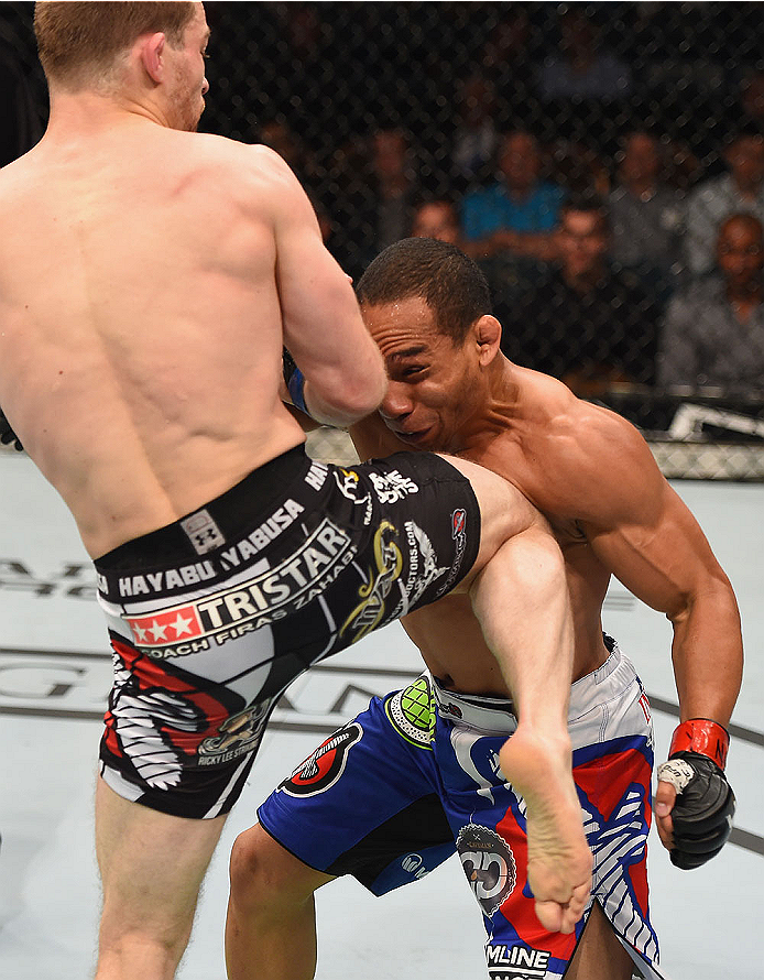 LAS VEGAS, NV - MAY 23:  (L-R) Zach Makovsky knees John Dodson in their flyweight bout during the UFC 187 event at the MGM Grand Garden Arena on May 23, 2015 in Las Vegas, Nevada.  (Photo by Josh Hedges/Zuffa LLC/Zuffa LLC via Getty Images)