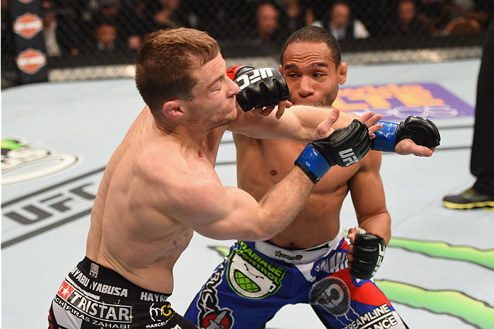 LAS VEGAS, NV - MAY 23:  (R-L) John Dodson punches Zach Makovsky in their flyweight bout during the UFC 187 event at the MGM Grand Garden Arena on May 23, 2015 in Las Vegas, Nevada.  (Photo by Josh Hedges/Zuffa LLC/Zuffa LLC via Getty Images)