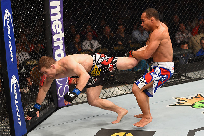 LAS VEGAS, NV - MAY 23: (R-L) John Dodson attempts to take down Zach Makovsky in their flyweight bout during the UFC 187 event at the MGM Grand Garden Arena on May 23, 2015 in Las Vegas, Nevada. (Photo by Josh Hedges/Zuffa LLC/Zuffa LLC via Getty Images