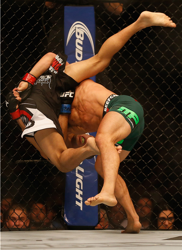 LAS VEGAS, NV - MAY 23:  Joseph Benavidez (right) slams John Moraga in their flyweight bout during the UFC 187 event at the MGM Grand Garden Arena on May 23, 2015 in Las Vegas, Nevada.  (Photo by Christian Petersen/Zuffa LLC/Zuffa LLC via Getty Images)