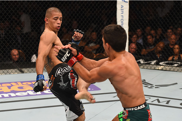LAS VEGAS, NV - MAY 23: (L-R) John Moraga kicks Joseph Benavidez in their flyweight bout during the UFC 187 event at the MGM Grand Garden Arena on May 23, 2015 in Las Vegas, Nevada. (Photo by Josh Hedges/Zuffa LLC/Zuffa LLC via Getty Images)