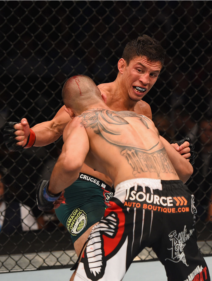 LAS VEGAS, NV - MAY 23:  Joseph Benavidez punches John Moraga (front) in their flyweight bout during the UFC 187 event at the MGM Grand Garden Arena on May 23, 2015 in Las Vegas, Nevada.  (Photo by Josh Hedges/Zuffa LLC/Zuffa LLC via Getty Images)