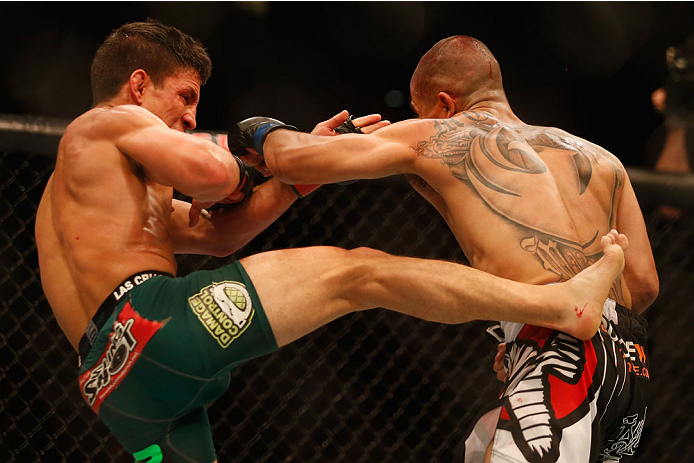 LAS VEGAS, NV - MAY 23:  (L-R) Joseph Benavidez kicks John Moraga in their flyweight bout during the UFC 187 event at the MGM Grand Garden Arena on May 23, 2015 in Las Vegas, Nevada.  (Photo by Christian Petersen/Zuffa LLC/Zuffa LLC via Getty Images)