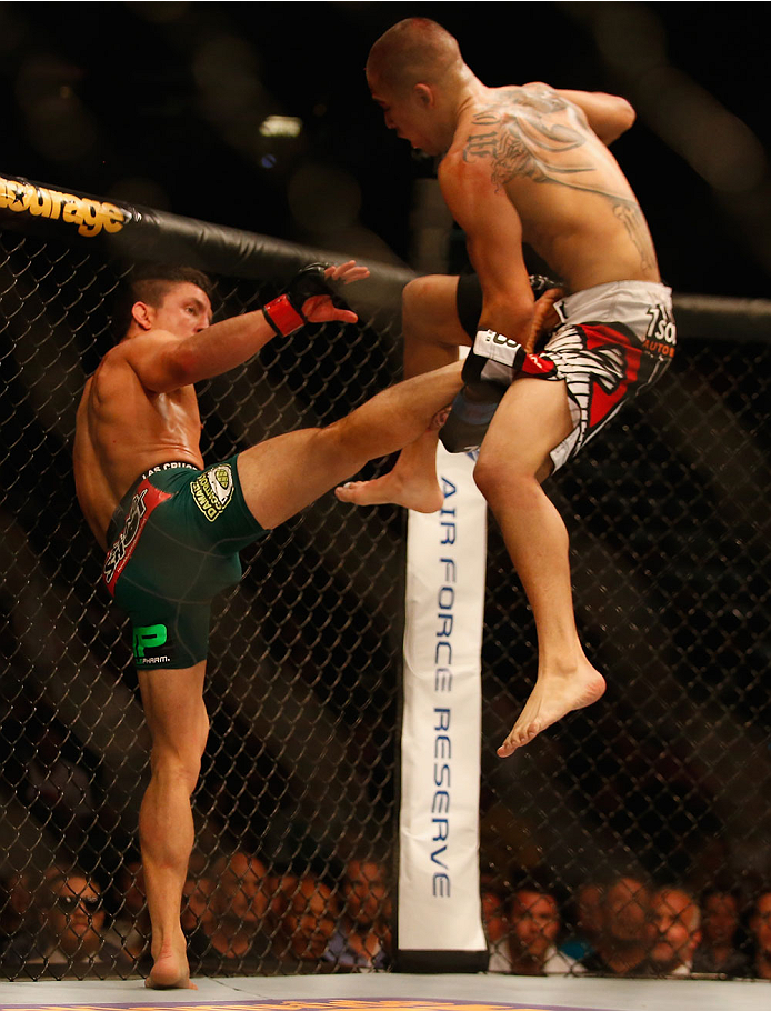 LAS VEGAS, NV - MAY 23:  (L-R) Joseph Benavidez kicks John Moraga in their flyweight bout during the UFC 187 event at the MGM Grand Garden Arena on May 23, 2015 in Las Vegas, Nevada.  (Photo by Christian Petersen/Zuffa LLC/Zuffa LLC via Getty Images)