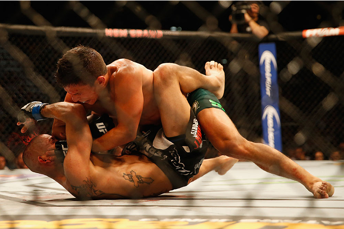 LAS VEGAS, NV - MAY 23:  Joseph Benavidez (top) elbows John Moraga in their flyweight bout during the UFC 187 event at the MGM Grand Garden Arena on May 23, 2015 in Las Vegas, Nevada.  (Photo by Christian Petersen/Zuffa LLC/Zuffa LLC via Getty Images)