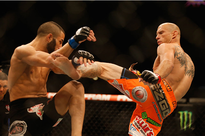 LAS VEGAS, NV - MAY 23: (R-L) Donald Cerrone kicks John Makdessi of Canada in their lightweight bout during the UFC 187 event at the MGM Grand Garden Arena on May 23, 2015 in Las Vegas, Nevada. (Photo by Christian Petersen/Zuffa LLC/Zuffa LLC via Getty