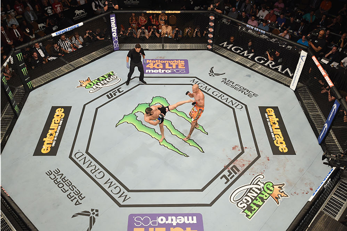 LAS VEGAS, NV - MAY 23:  (L-R) John Makdessi of Canada kicks Donald Cerrone in their lightweight bout during the UFC 187 event at the MGM Grand Garden Arena on May 23, 2015 in Las Vegas, Nevada.  (Photo by Josh Hedges/Zuffa LLC/Zuffa LLC via Getty Images)