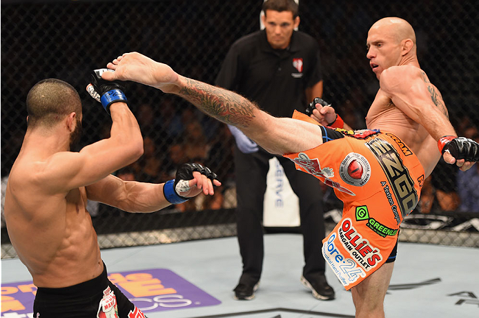 LAS VEGAS, NV - MAY 23:  (R-L) Donald Cerrone kicks John Makdessi of Canada in their lightweight bout during the UFC 187 event at the MGM Grand Garden Arena on May 23, 2015 in Las Vegas, Nevada.  (Photo by Josh Hedges/Zuffa LLC/Zuffa LLC via Getty Images)