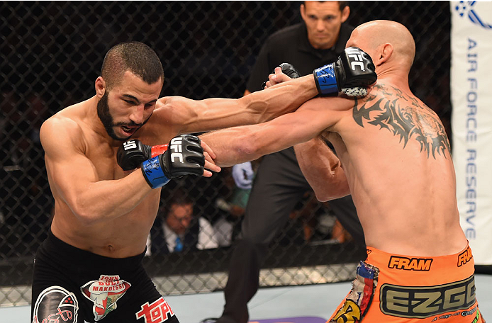 LAS VEGAS, NV - MAY 23: (L-R) John Makdessi of Canada and Donald Cerrone exchange punches in their lightweight bout during the UFC 187 event at the MGM Grand Garden Arena on May 23, 2015 in Las Vegas, Nevada. (Photo by Josh Hedges/Zuffa LLC/Zuffa LLC vi