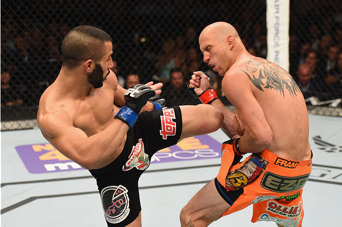 LAS VEGAS, NV - MAY 23:  (L-R) John Makdessi of Canada kicks Donald Cerrone in their lightweight bout during the UFC 187 event at the MGM Grand Garden Arena on May 23, 2015 in Las Vegas, Nevada.  (Photo by Josh Hedges/Zuffa LLC/Zuffa LLC via Getty Images)