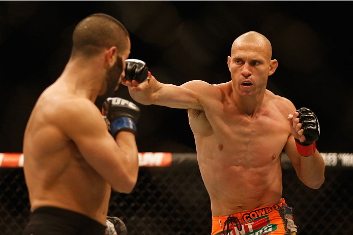 LAS VEGAS, NV - MAY 23:  (R-L) Donald Cerrone punches John Makdessi of Canada in their lightweight bout during the UFC 187 event at the MGM Grand Garden Arena on May 23, 2015 in Las Vegas, Nevada.  (Photo by Christian Petersen/Zuffa LLC/Zuffa LLC via Gett