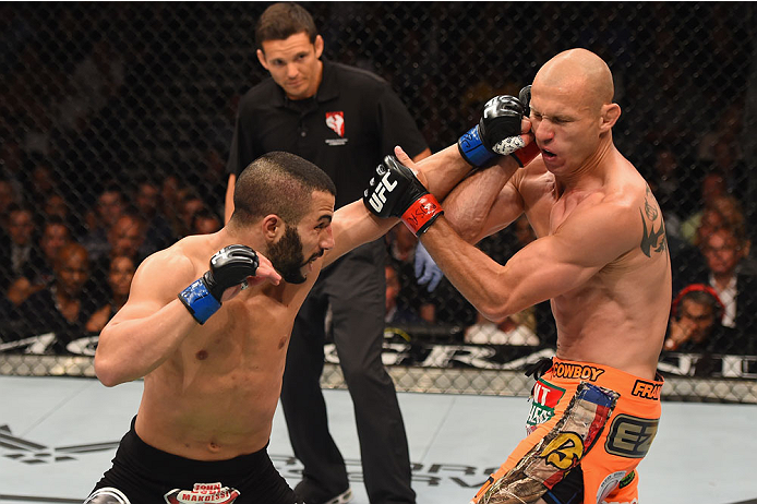 LAS VEGAS, NV - MAY 23:  (L-R) John Makdessi of Canada punches Donald Cerrone in their lightweight bout during the UFC 187 event at the MGM Grand Garden Arena on May 23, 2015 in Las Vegas, Nevada.  (Photo by Josh Hedges/Zuffa LLC/Zuffa LLC via Getty Image