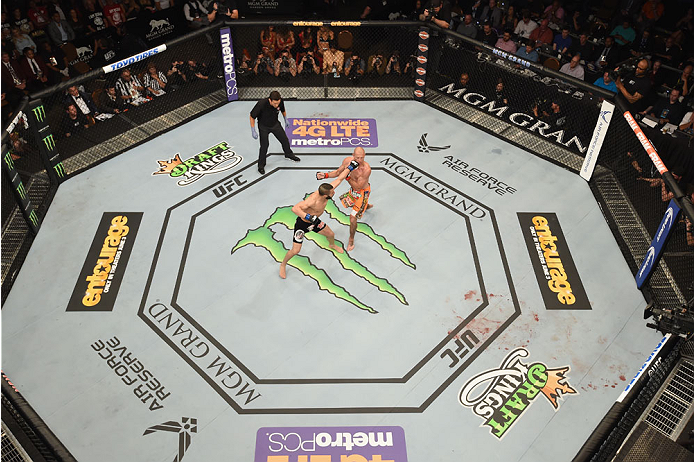 LAS VEGAS, NV - MAY 23:  (L-R) John Makdessi of Canada punches Donald Cerrone in their lightweight bout during the UFC 187 event at the MGM Grand Garden Arena on May 23, 2015 in Las Vegas, Nevada.  (Photo by Josh Hedges/Zuffa LLC/Zuffa LLC via Getty Image